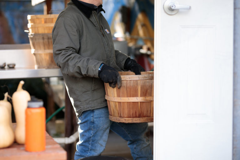 man carrying wooden bucket