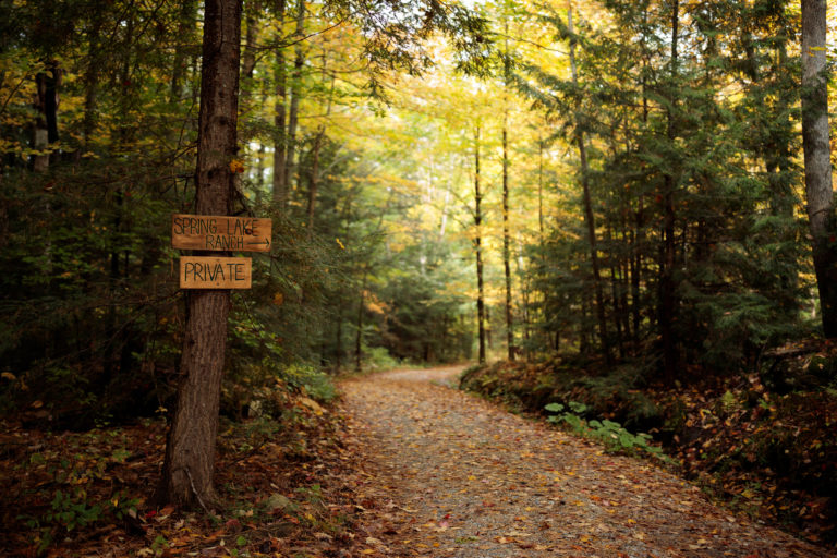 path in woods with sign towards spring lake ranch